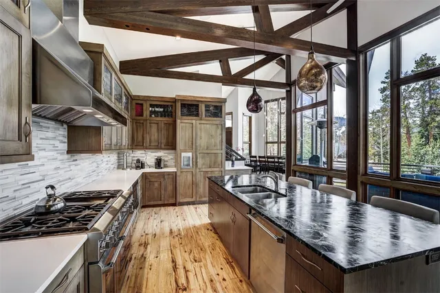 a kitchen with stainless steel appliances granite countertop a stove and a sink