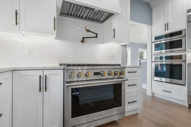 a kitchen with stainless steel appliances kitchen island a refrigerator and a microwave