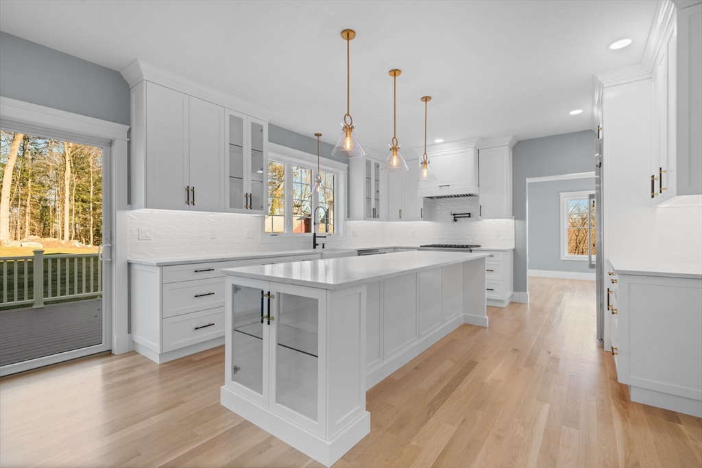 1 A Highland Way Burlington, MA 01803 - Photo 19 of 42 a open kitchen with kitchen island white cabinets and stainless steel appliances