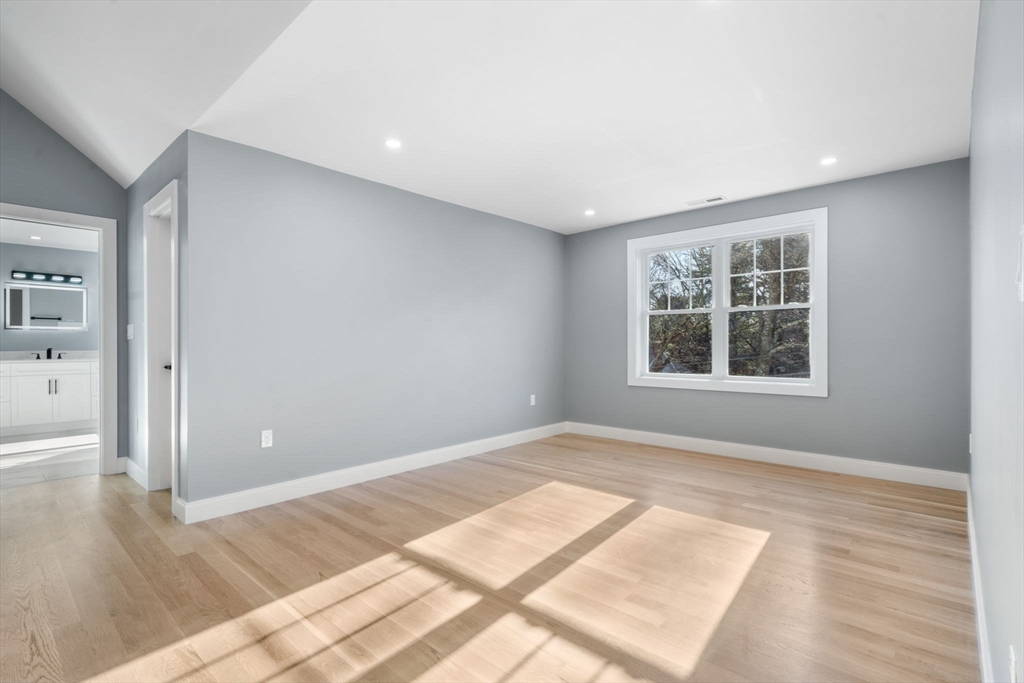 1 A Highland Way Burlington, MA 01803 - Photo 32 of 42 a view of an empty room with wooden floor and a window