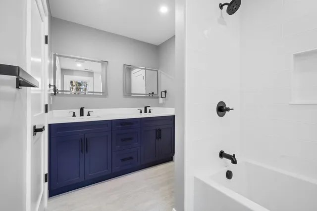 a view of staircase with railing and white walls