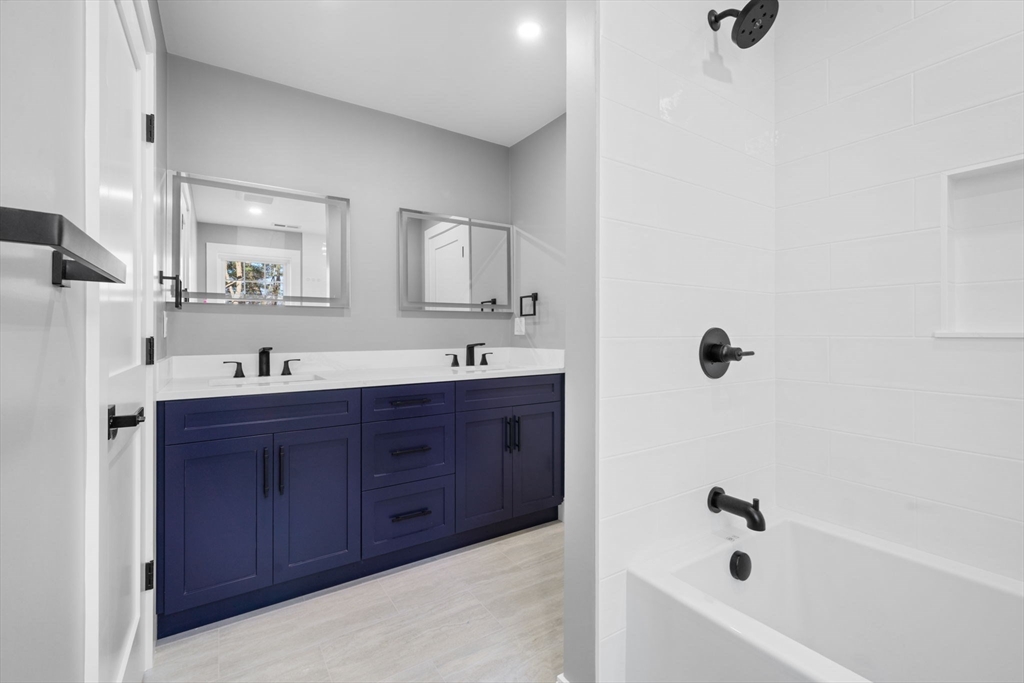 1 A Highland Way Burlington, MA 01803 - Photo 36 of 42 a bathroom with a tub sink and mirror