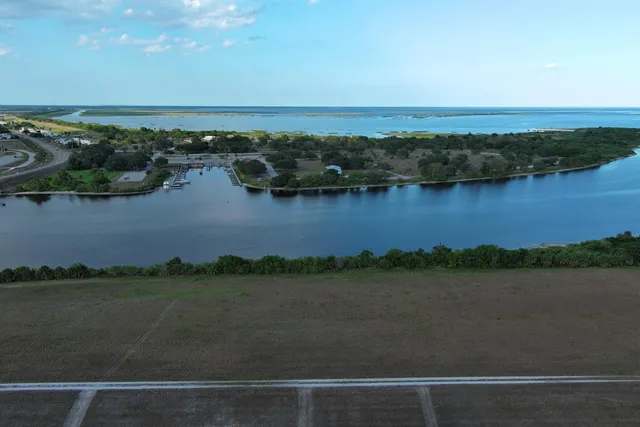 an aerial view of residential building with outdoor space and lake