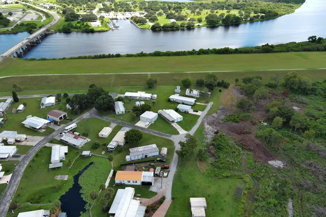 an aerial view of a houses with outdoor space and lake view