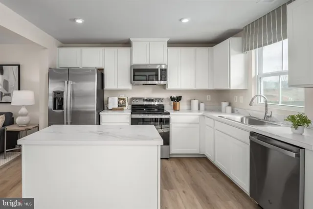 a kitchen with refrigerator a sink and cabinets