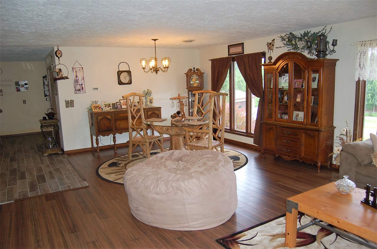 16085 West Hazelview Road Polo, IL 61064 - Photo 4 of 25 a view of a livingroom with furniture wooden floor and a kitchen