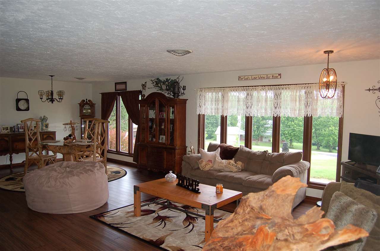 16085 West Hazelview Road Polo, IL 61064 - Photo 5 of 25 a living room with furniture a flat screen tv and a large window