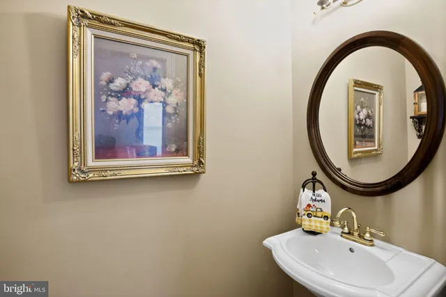 a living room with furniture a rug and white walls