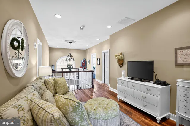 a room with painting on the wall and a potted plant
