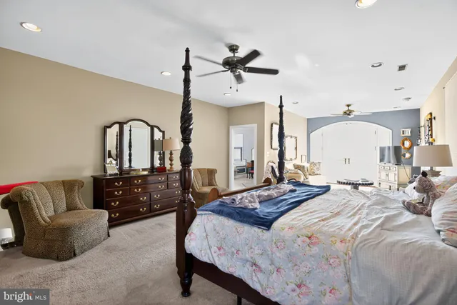 a view of hallway with wooden floor and cabinets
