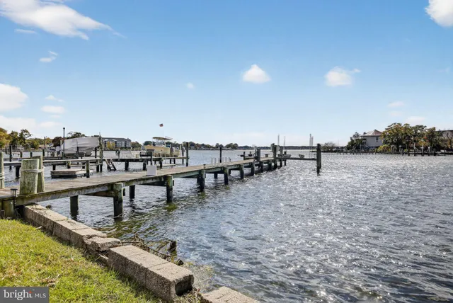 a view of a house with a swimming pool and a yard