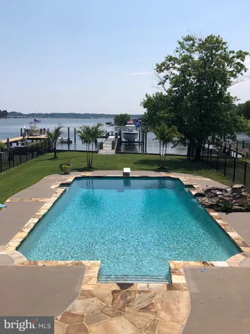 a living room with furniture fireplace and wooden floor