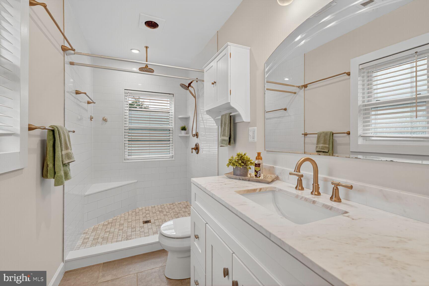 5021 25th Road North Arlington, VA 22207 - Photo 11 of 35 a bathroom with a granite countertop sink toilet and shower