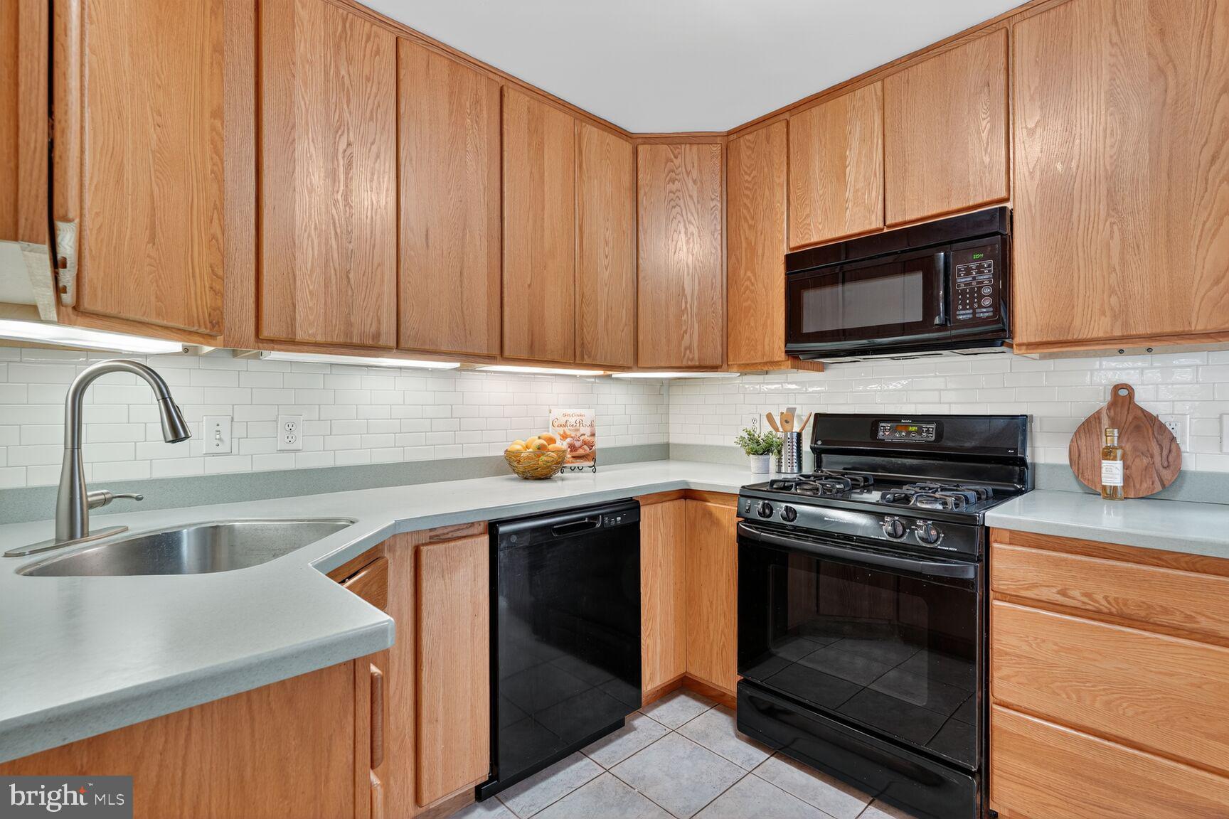 5021 25th Road North Arlington, VA 22207 - Photo 15 of 35 a kitchen with granite countertop wooden cabinets a stove top oven and granite countertops