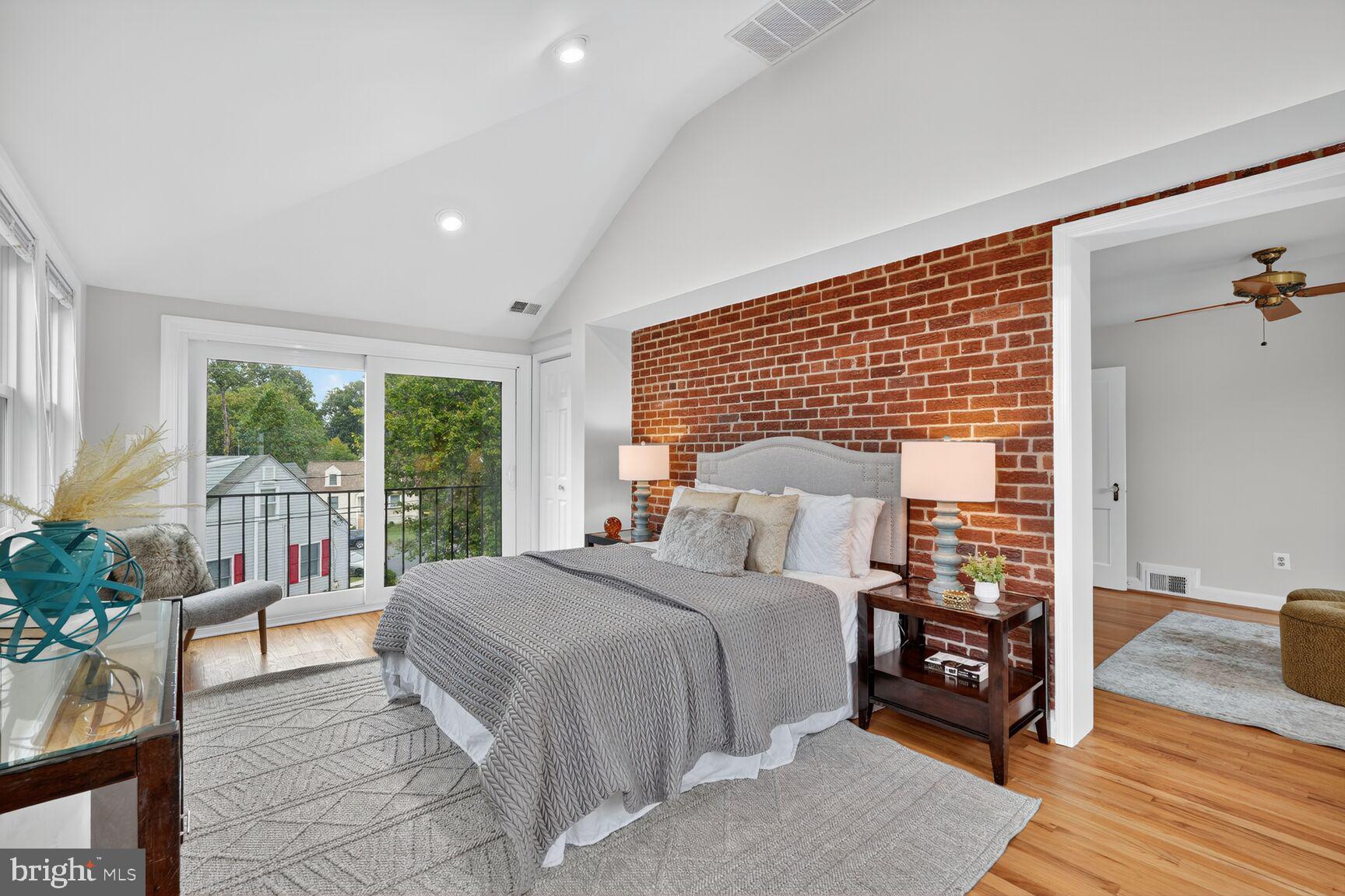 5021 25th Road North Arlington, VA 22207 - Photo 16 of 35 a bedroom with a bed a table and a potted plant