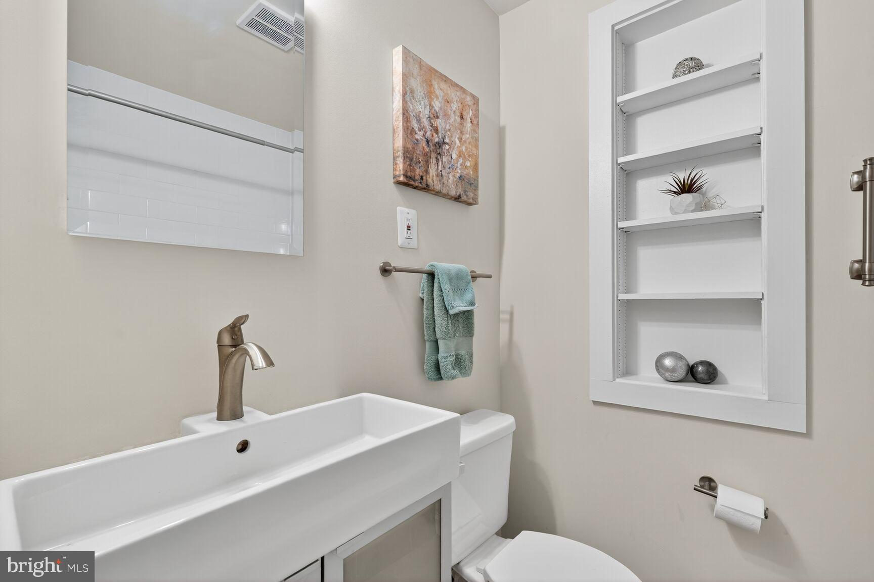 5021 25th Road North Arlington, VA 22207 - Photo 21 of 35 a bathroom with a sink mirror and toilet