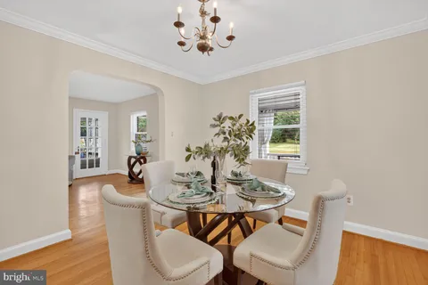 a view of a dining room with furniture and chandelier