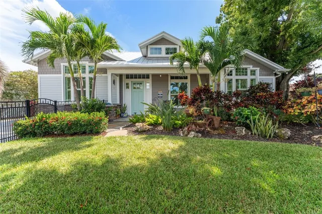 a front view of a house with a garden and plants