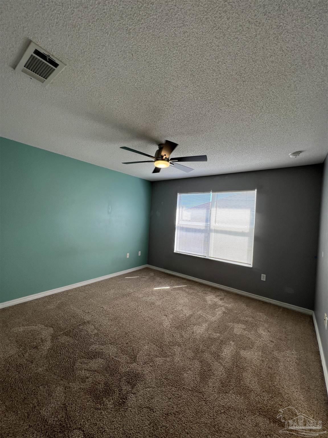 120 Nivana Drive Crestview, FL 32536 - Photo 14 of 20 an empty room with windows and fan