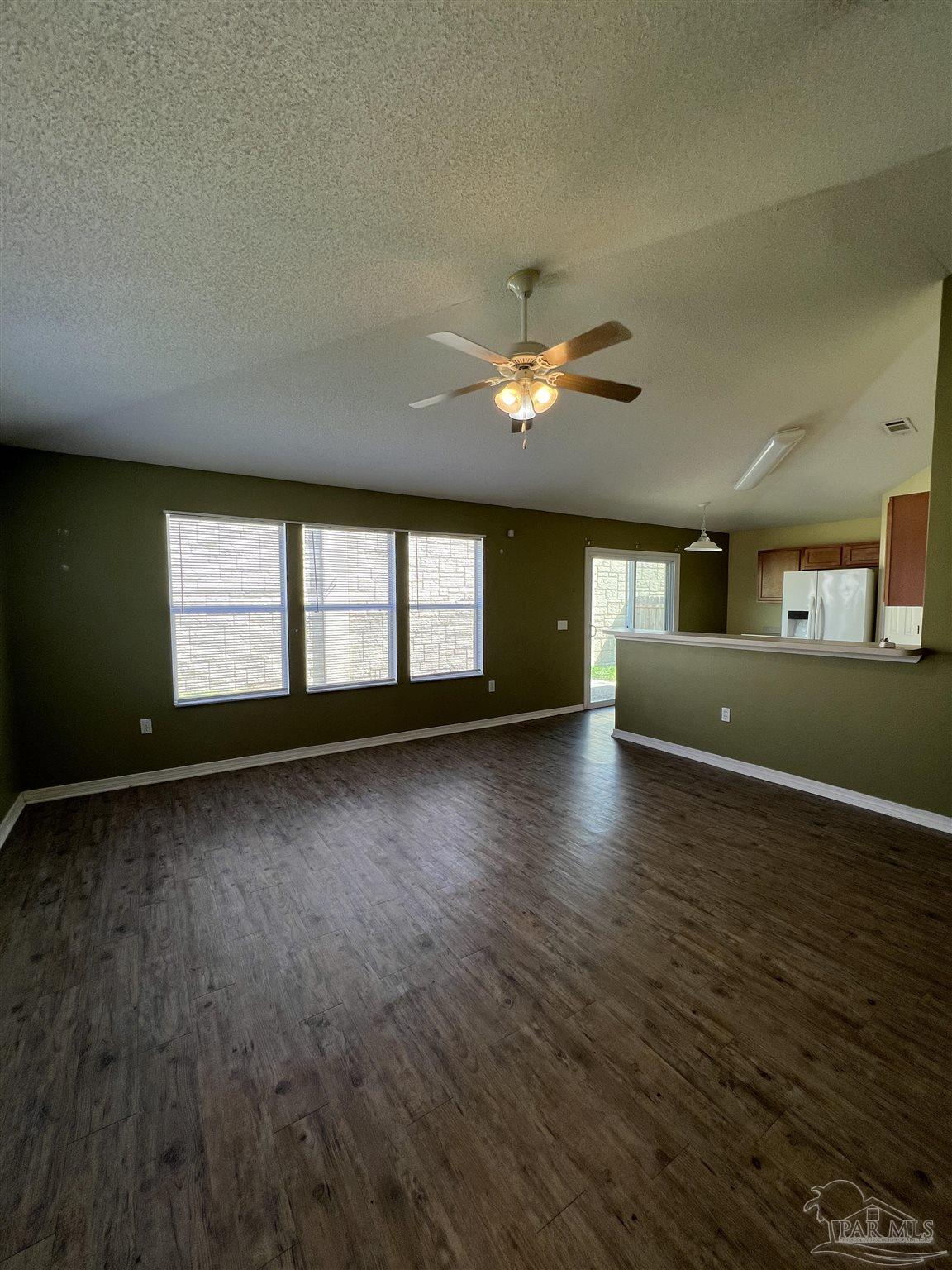 120 Nivana Drive Crestview, FL 32536 - Photo 2 of 20 an empty room with wooden floor and windows