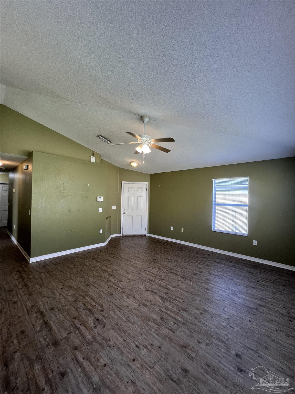 120 Nivana Drive Crestview, FL 32536 - Photo 3 of 20 a view of an empty room with window and wooden floor