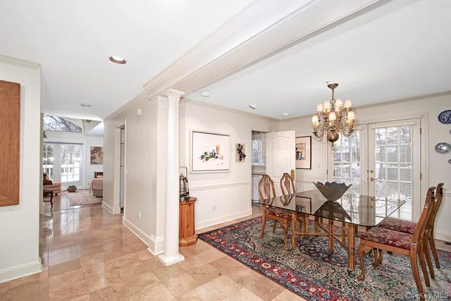 a view of a dining room with furniture and chandelier