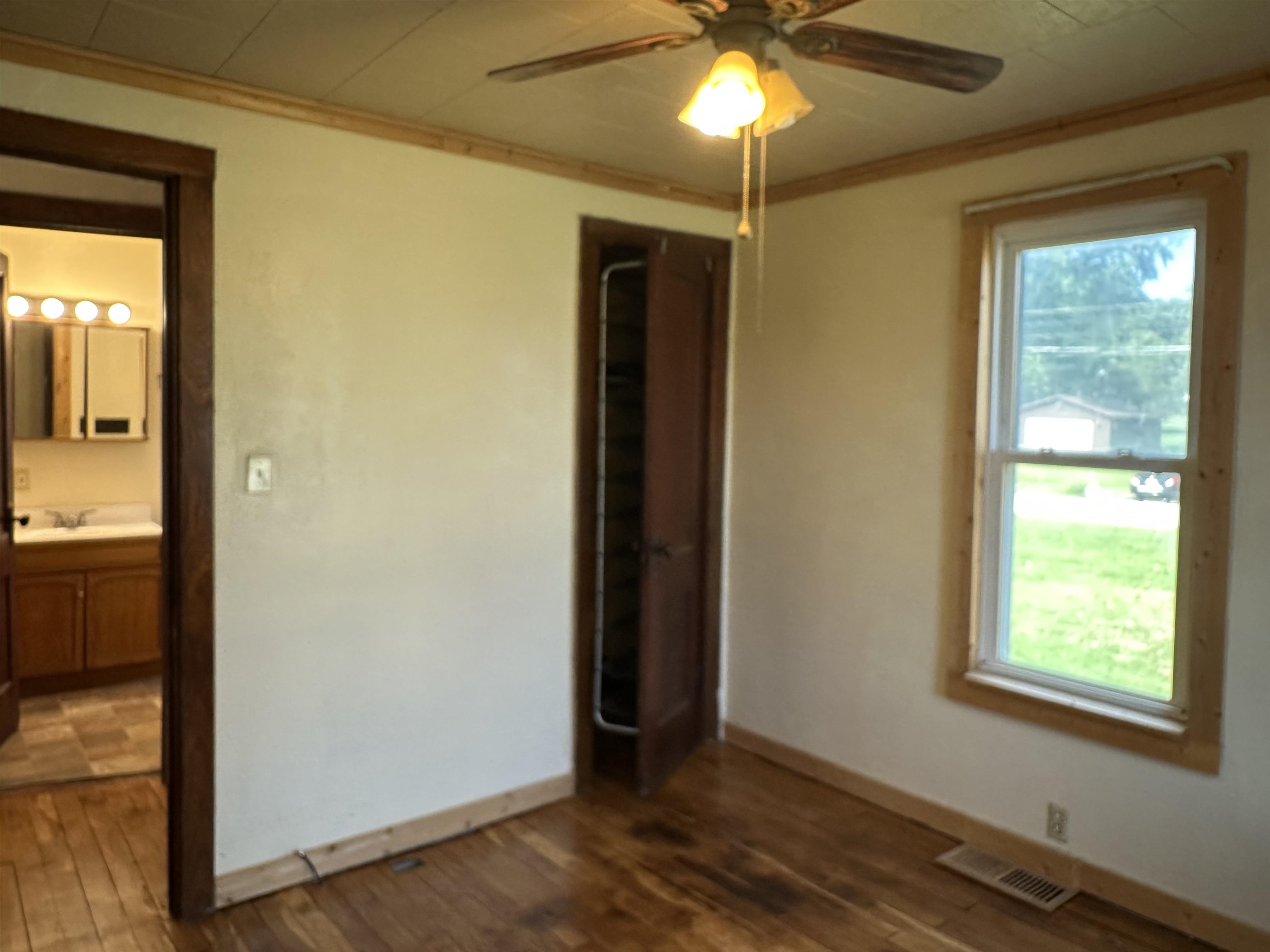 1407 Hawthorne Avenue Savanna, IL 61074 - Photo 13 of 20 a view of an empty room with window and wooden floor