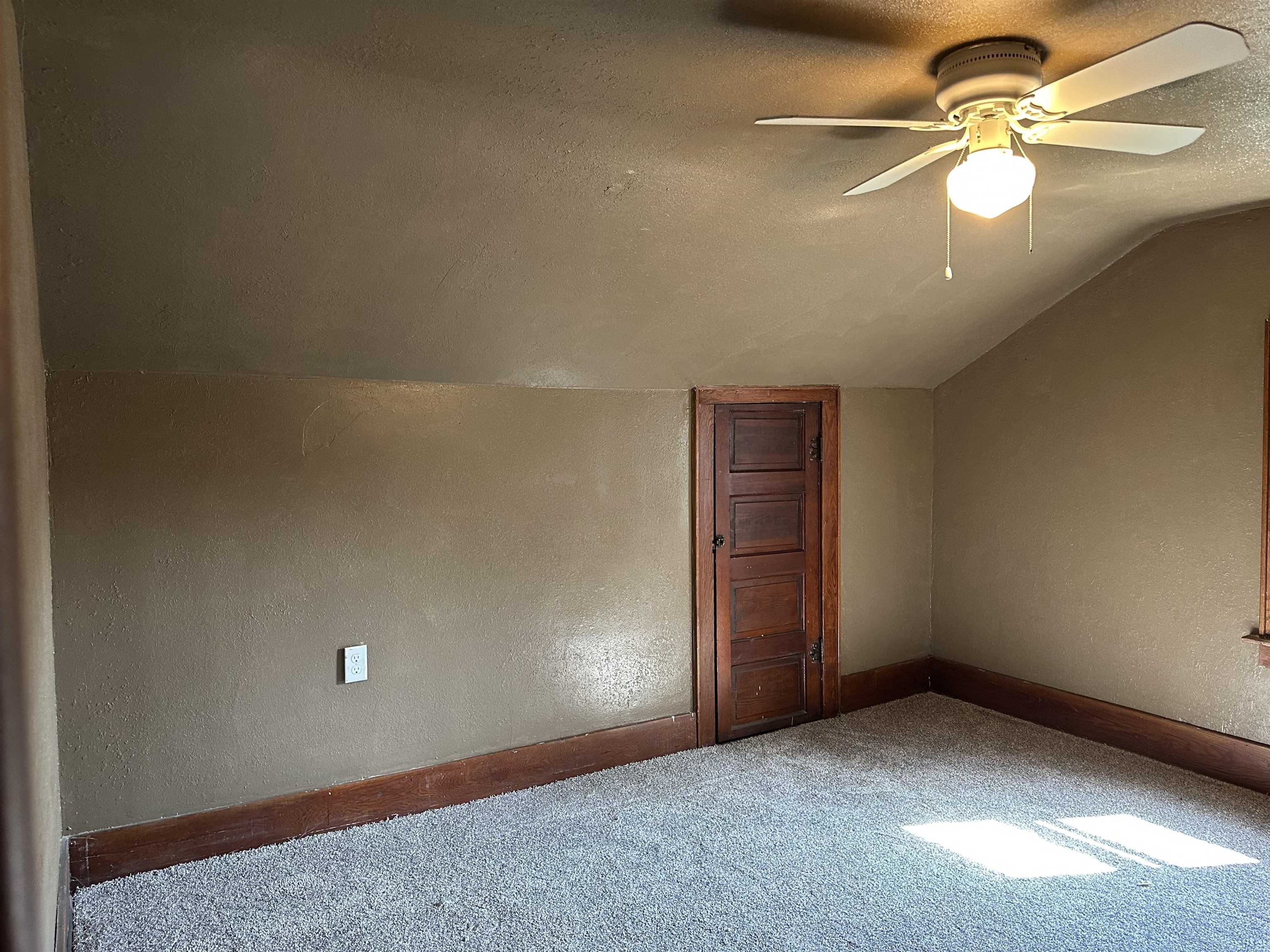 1407 Hawthorne Avenue Savanna, IL 61074 - Photo 15 of 20 an empty room with a chandelier fan and windows