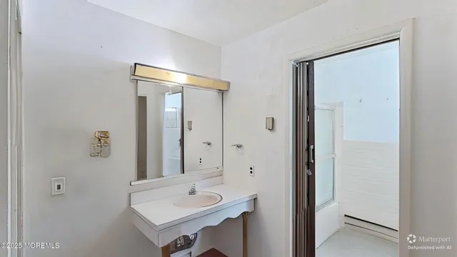 a bathroom with a sink a mirror and a shower
