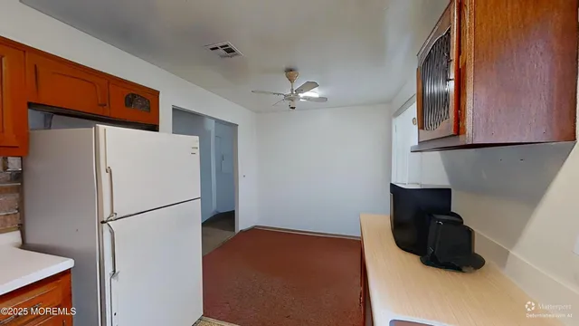 a kitchen with stainless steel appliances a refrigerator and a stove top oven