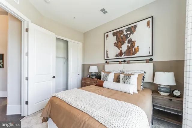 a bedroom with a bed and wall painting