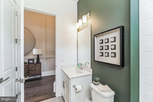 a bathroom with a toilet sink and mirror