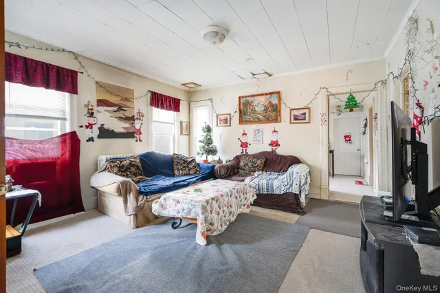 a bedroom with furniture and a flat screen tv