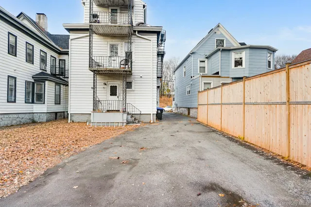 a view of a car park in front of a house