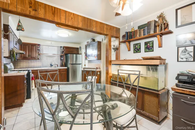 a kitchen with stainless steel appliances kitchen island granite countertop a table and chairs