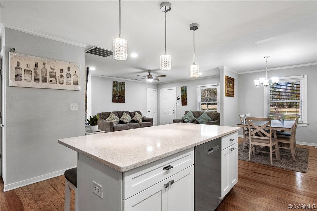 10111 Cattail Road Chesterfield, VA 23838 - Photo 13 of 31 a kitchen with a stove a kitchen island with chairs and wooden floor