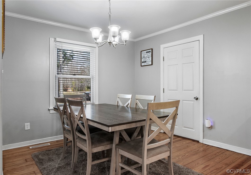 10111 Cattail Road Chesterfield, VA 23838 - Photo 15 of 31 a view of a dining room with furniture and wooden floor