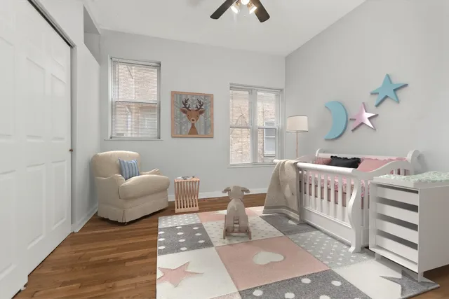 a bedroom with furniture and wooden floor