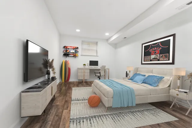 a bedroom with furniture and a flat screen tv
