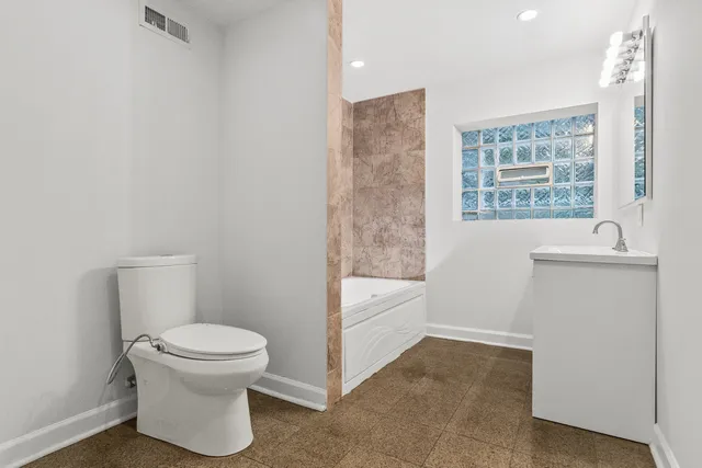 a bathroom with a toilet and a bathtub