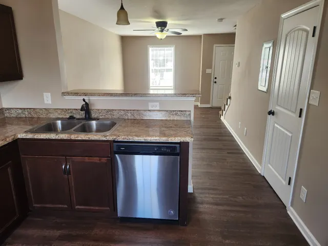 a kitchen with a sink stove and refrigerator
