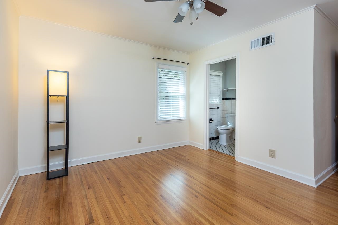 4696 Kaye Road Memphis, TN 38117 - Photo 13 of 39 an empty room with wooden floor and windows
