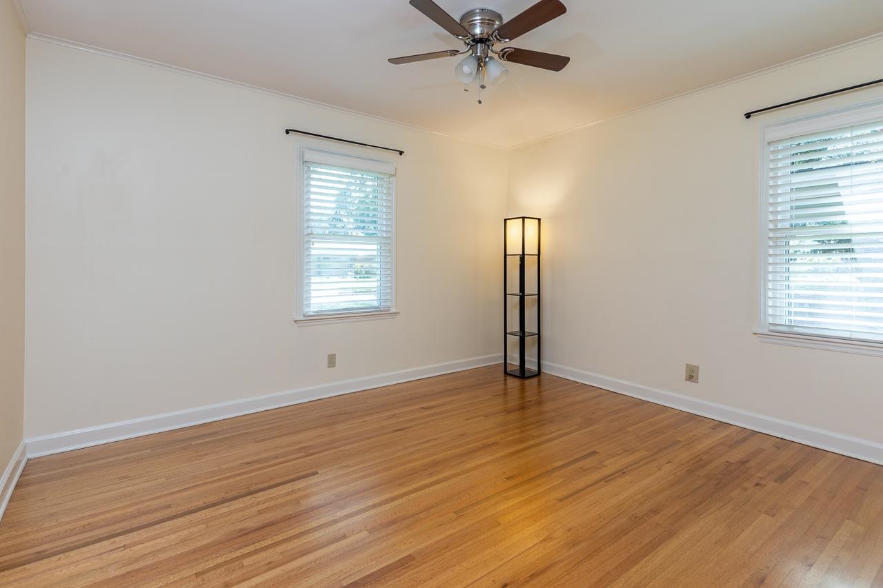 4696 Kaye Road Memphis, TN 38117 - Photo 14 of 39 a view of an empty room with wooden floor and a window