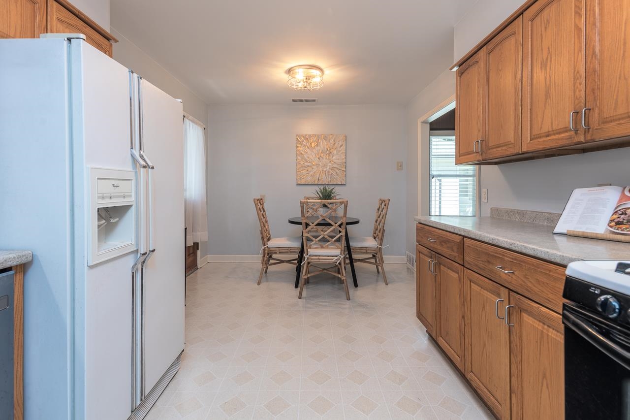 4696 Kaye Road Memphis, TN 38117 - Photo 20 of 39 a kitchen with stainless steel appliances kitchen island granite countertop a refrigerator and a stove top oven