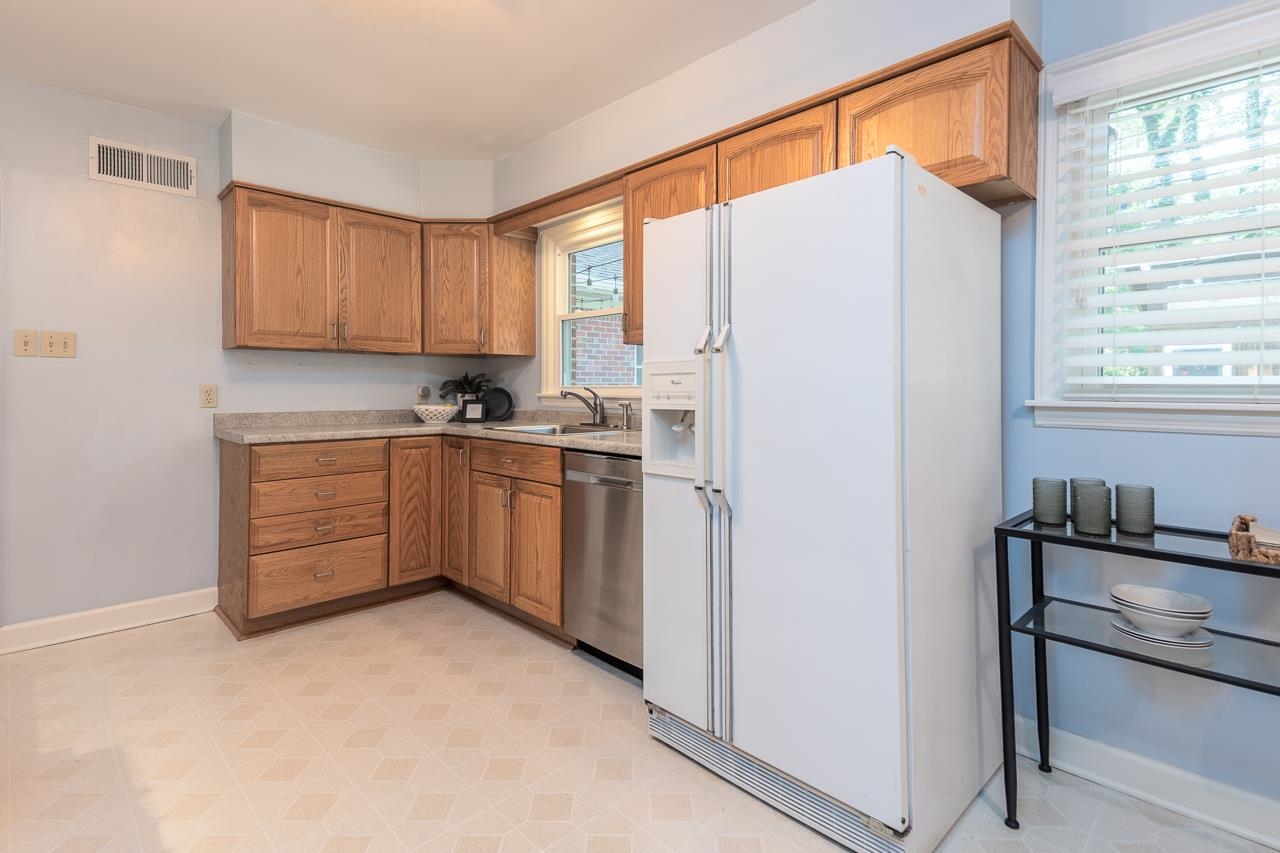 4696 Kaye Road Memphis, TN 38117 - Photo 21 of 39 a kitchen with white cabinets and white appliances