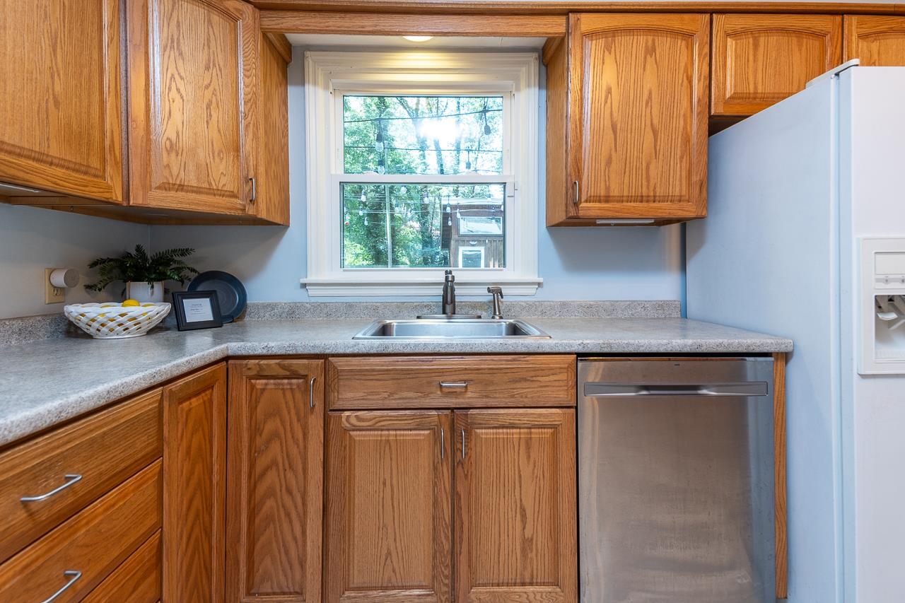 4696 Kaye Road Memphis, TN 38117 - Photo 24 of 39 a kitchen with stainless steel appliances granite countertop a sink dishwasher and cabinets with wooden floor