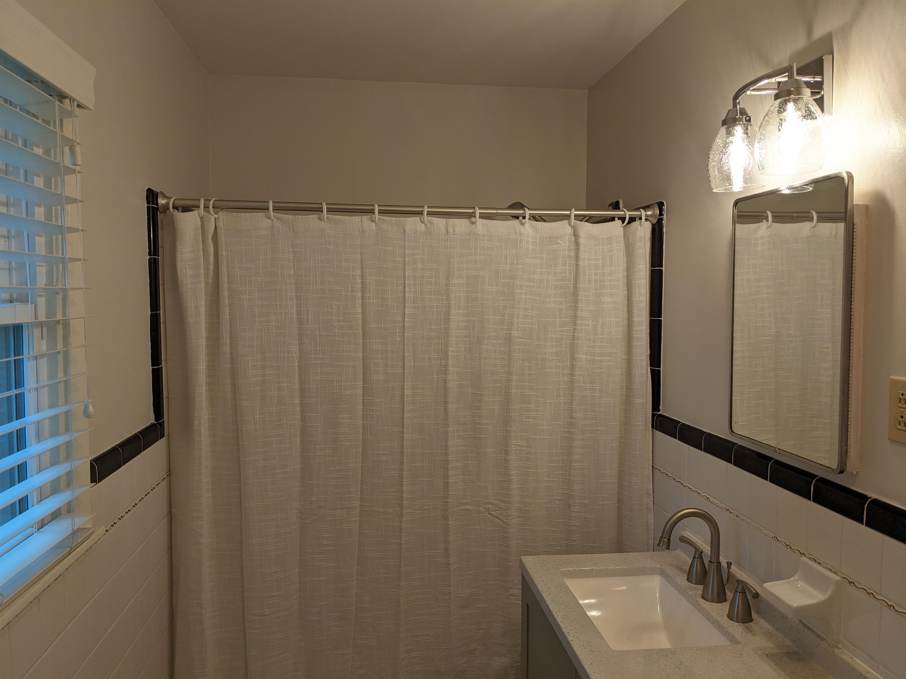 4696 Kaye Road Memphis, TN 38117 - Photo 26 of 39 a bathroom with a sink a mirror and shower curtain