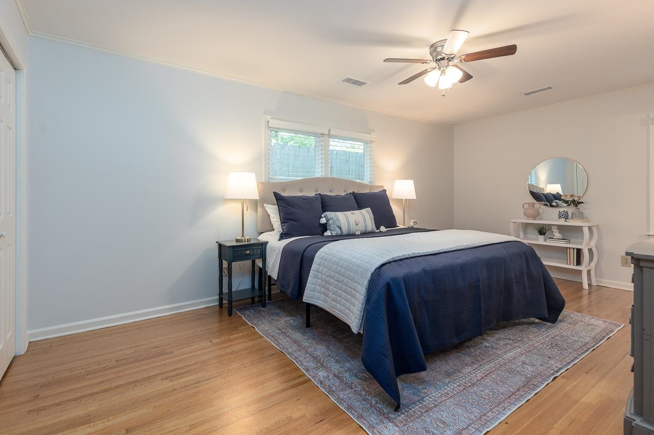 4696 Kaye Road Memphis, TN 38117 - Photo 10 of 39 a bedroom with a large bed chandelier and a window