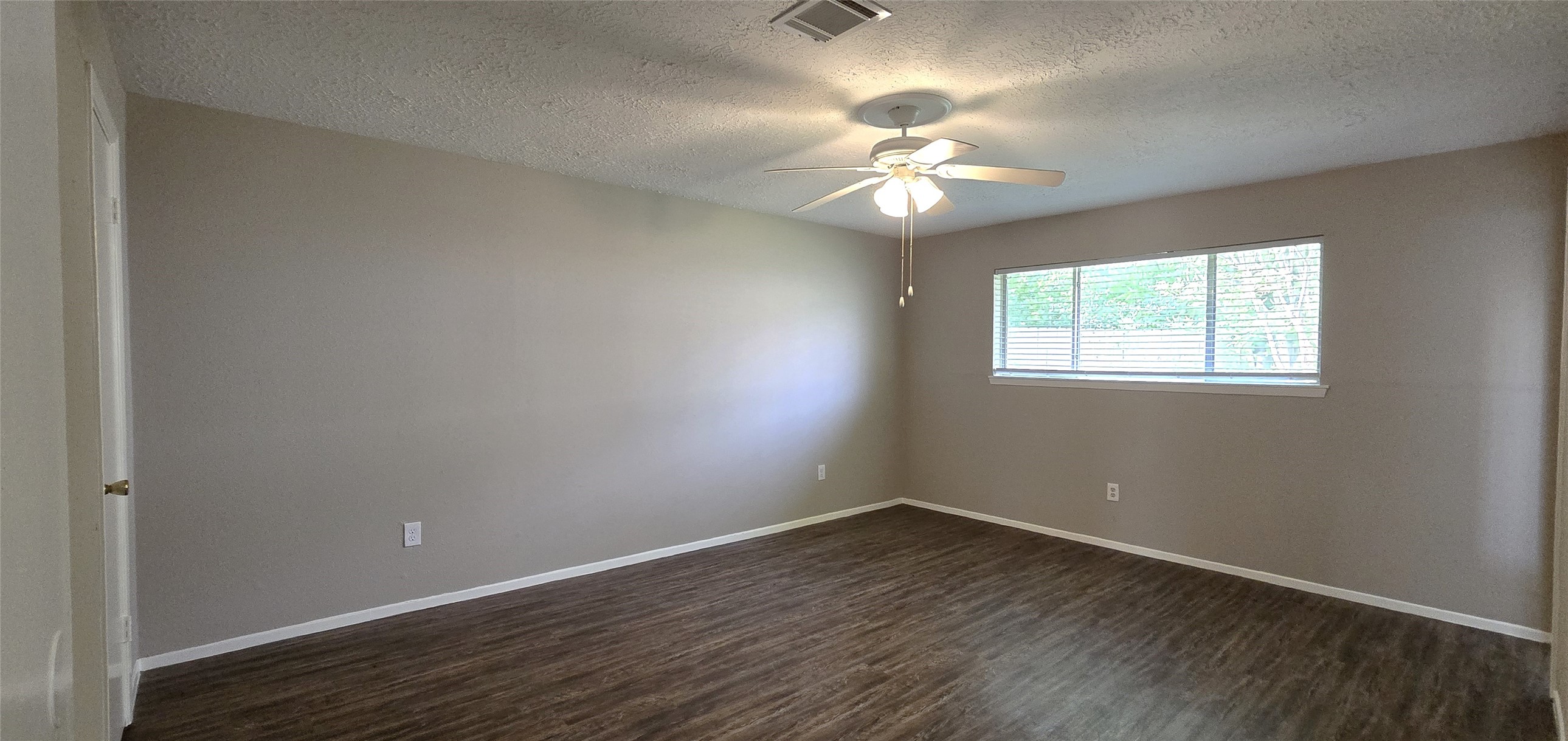 23019 Tree Bright Lane Spring, TX 77373 - Photo 14 of 20 Primary bedroom includes a walk-in closet, en-suite bathroom, a ceiling fan with light and a large window overlooking the backyard.