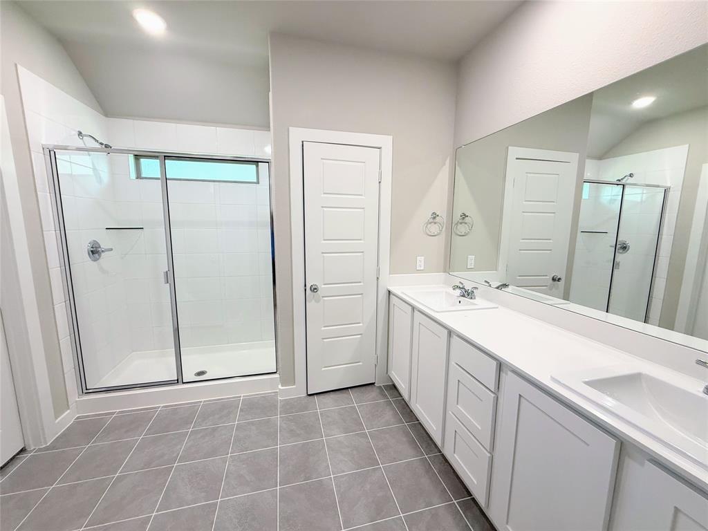 1909 Sandpiper Way Princeton, TX 75407 - Photo 13 of 35 Full bath with a shower stall, double vanity, light tile patterned floors, and recessed lighting